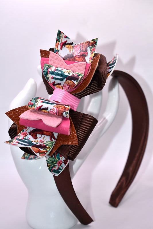 Saddle up, partner! 🤠 This one-of-a-kind headband brings serious cowgirl vibes with its charming faux leather and ribbon motif in gorgeous shades of brown and pink. 🌸 The wide silk construction keeps things comfy all day long, while the flexible design moves with you—no pinching, no fussing. Whether you're channeling your inner rodeo queen or just want to add some playful Western flair to your look, this beauty delivers style with zero compromise. 💕 Yeehaw!