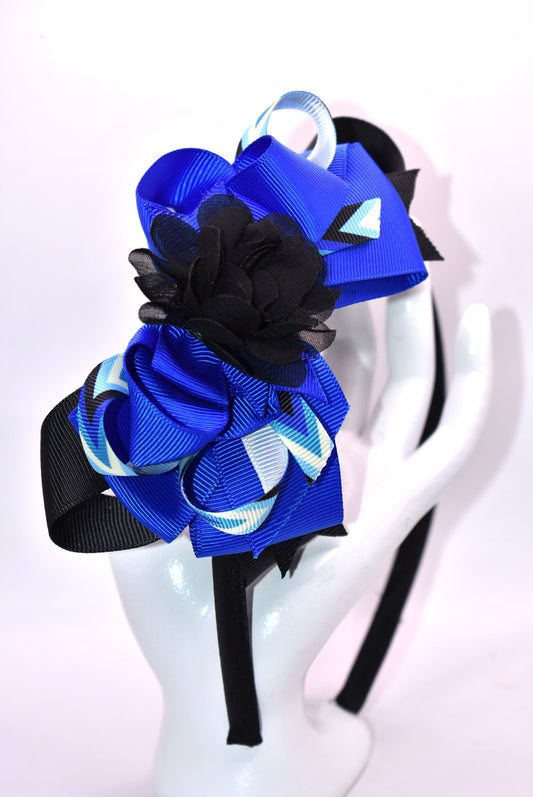 ✨ Elevate your look with this stunning blue and black headband from Nana's Collection! Crafted from silky satin for all-day comfort, this thin, lightweight design features beautifully layered ribbons that add dimension and style. Topped with an elegant black chiffon flower, it's the perfect finishing touch for any outfit—from casual days to special occasions. 🎀 Whether you're dressing up or keeping it simple, this headpiece brings that extra touch of pretty to your ensemble. 💙