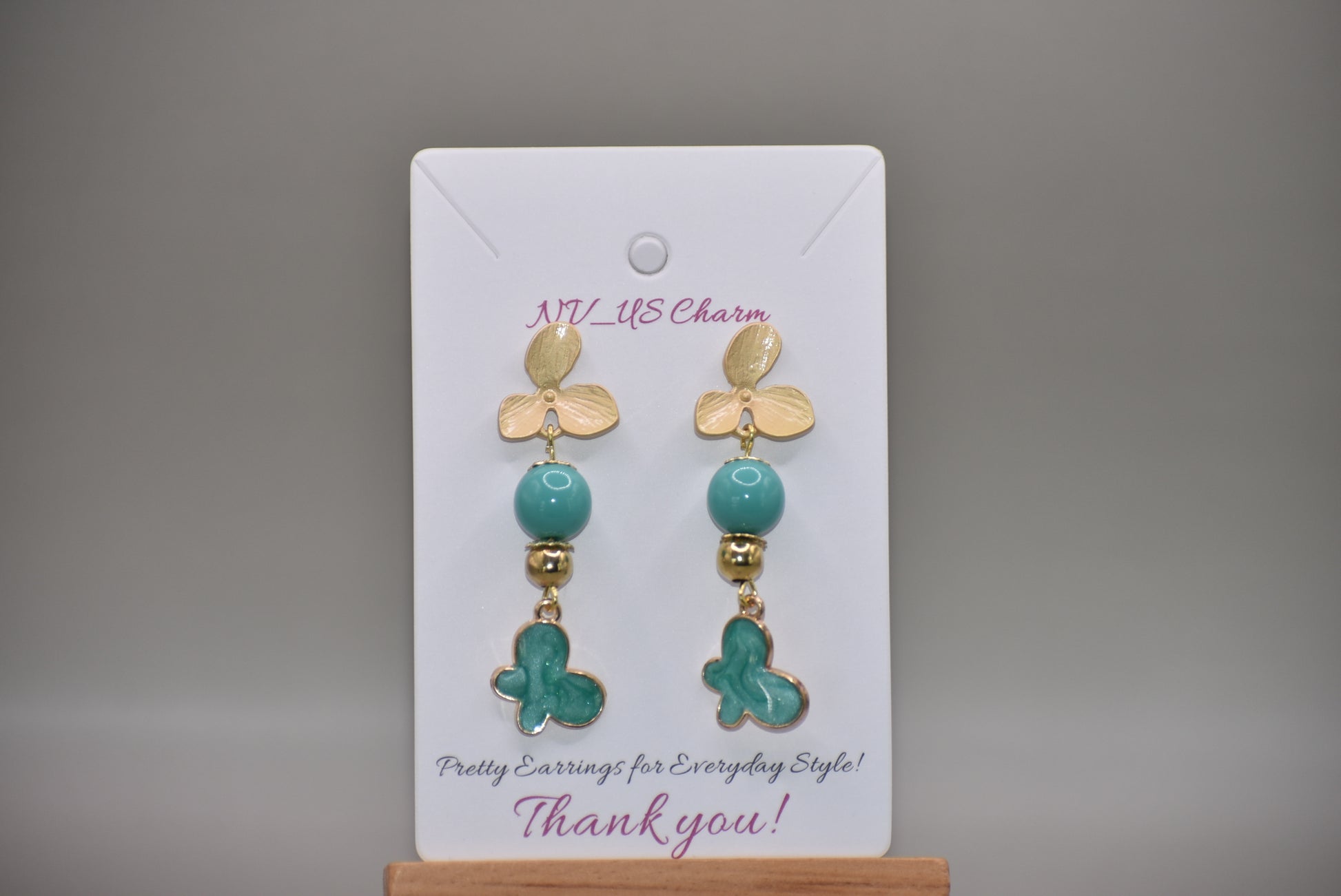 The Green Collection 23 earrings are the perfect addition to any outfit. These elegant earrings feature brushed gold flower posts with pretty jade beading and gold accents. A stunning green charm hangs from the posts, completing the look.