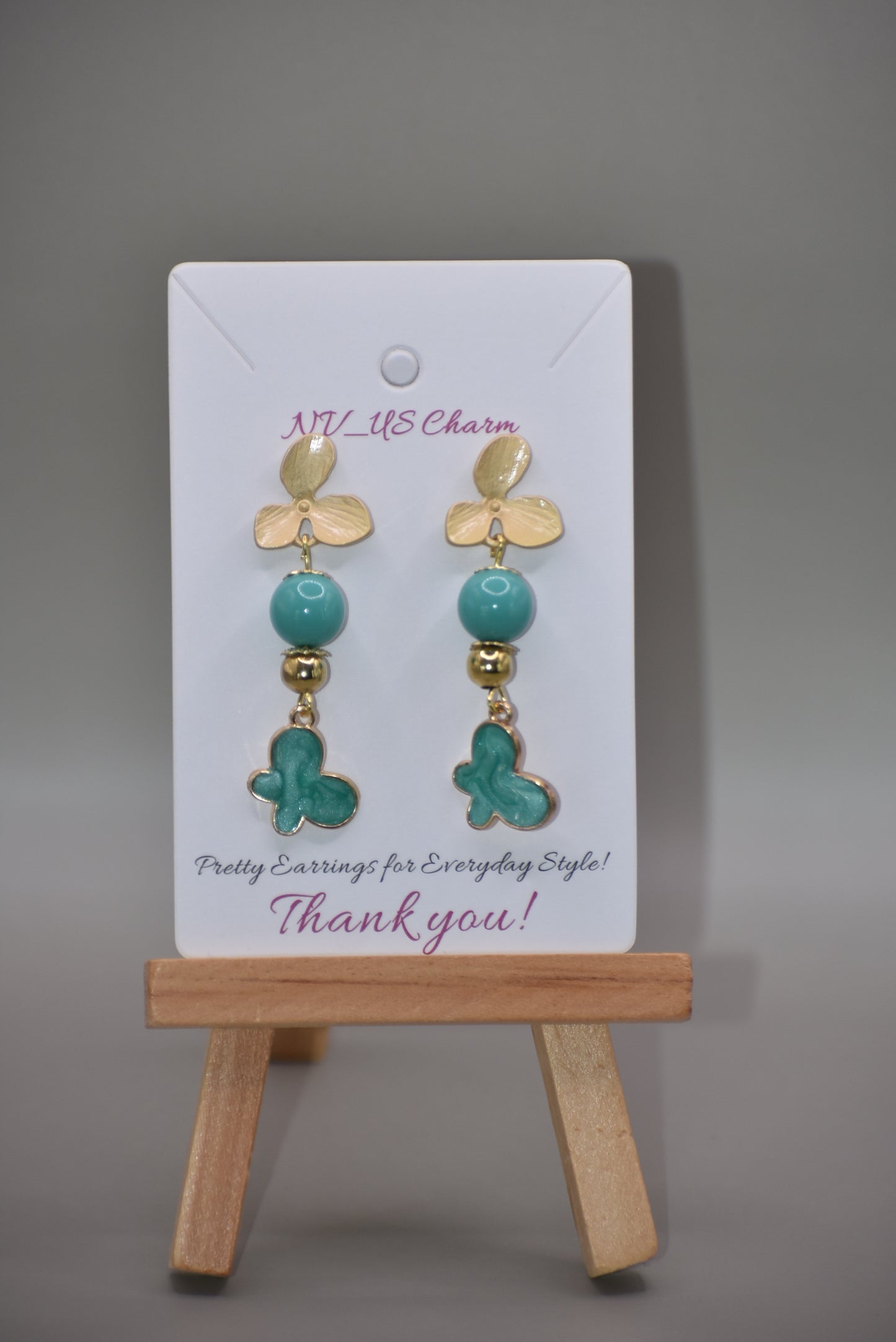 The Green Collection 23 earrings are the perfect addition to any outfit. These elegant earrings feature brushed gold flower posts with pretty jade beading and gold accents. A stunning green charm hangs from the posts, completing the look.