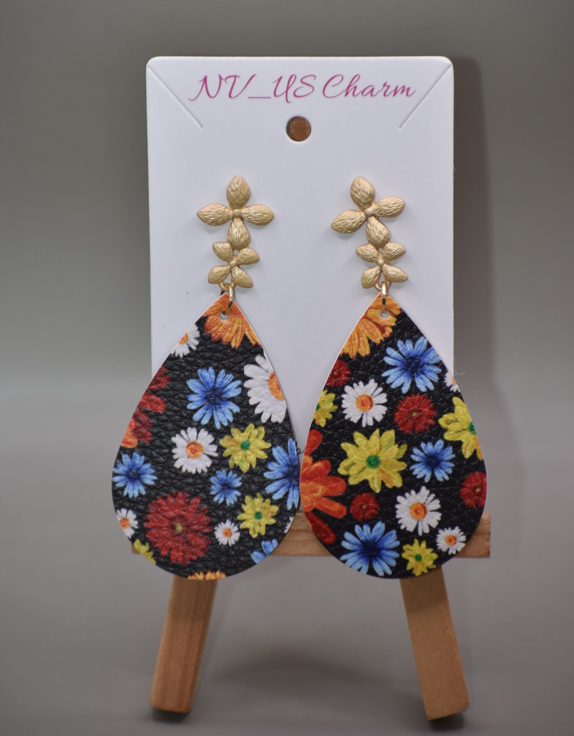 Add a pop of color and quirkiness to any outfit with our Key West Collection earrings! The super fun and bright design features a black background with a vibrant, multi-colored flowered pattern. The unique gold posts add a touch of whimsy, making these earrings truly one-of-a-kind. Get ready to fall in love with these unique flower posts!" 🌺💛