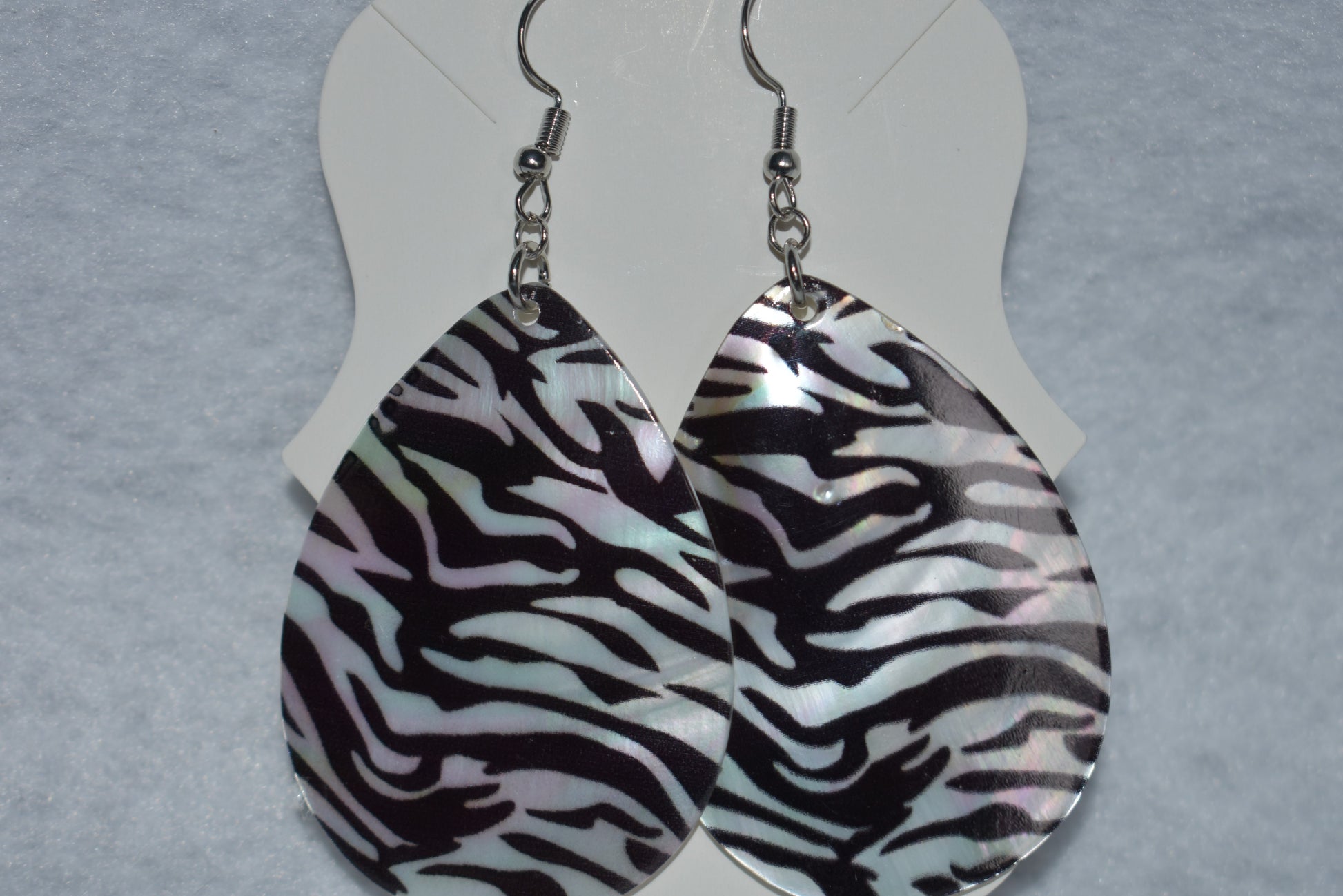 his Zebra pattern hanging earring is perfect for a fancy dress or just a pair of jeans. 