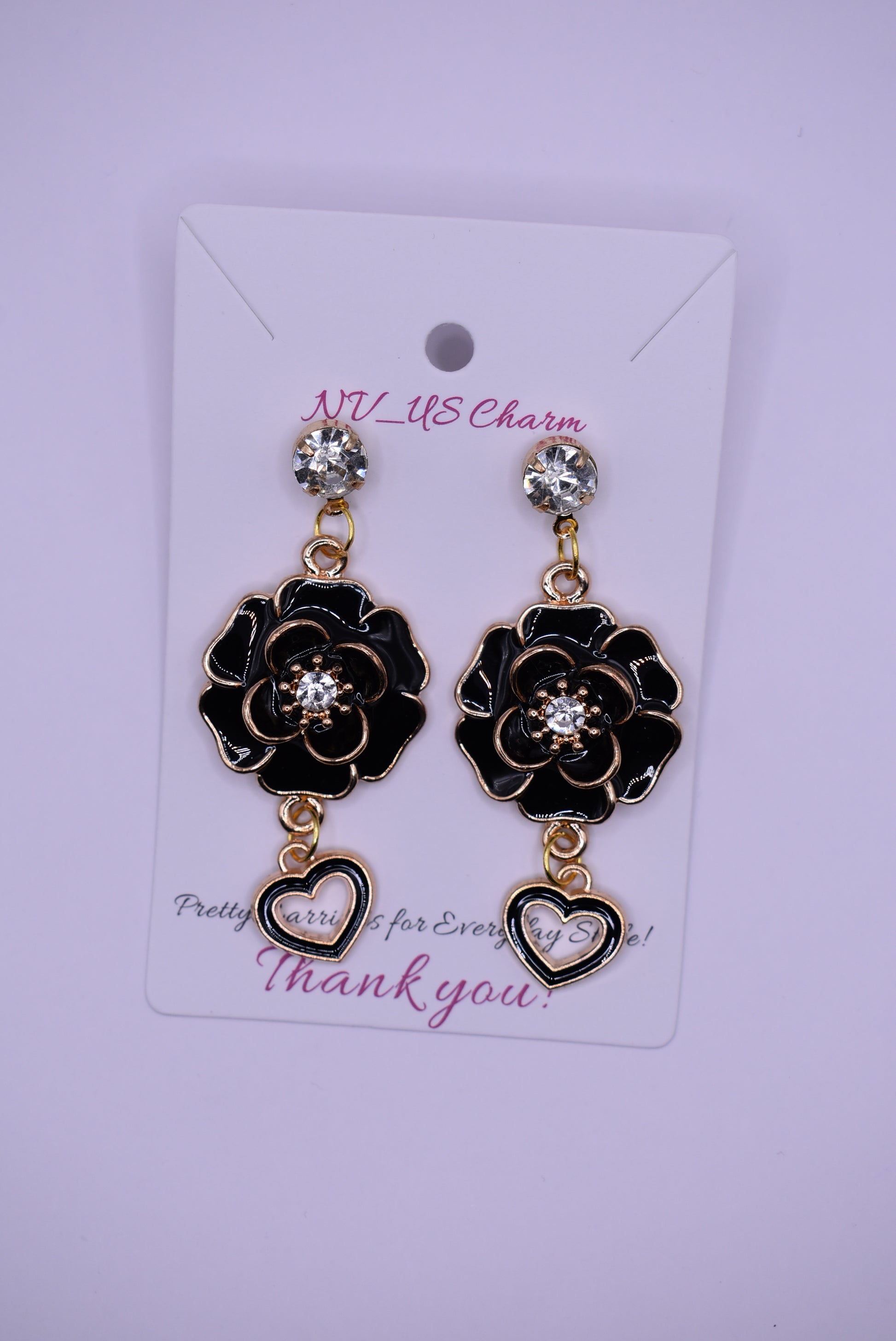 ﻿These black beauties are diamond posts with black flowers with middle crystal and have a hanging black open heart on the bottom.  They are on the heavier side. Gorgeous on the ear.  One-of-a-kind piece.