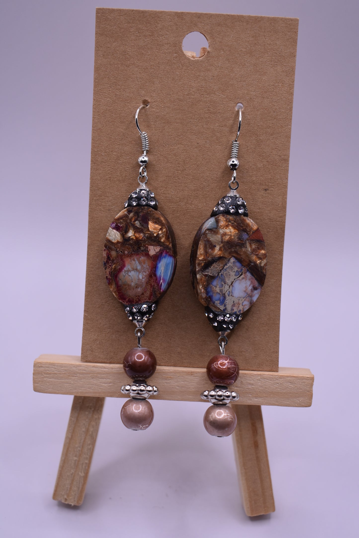 These silver hanging earrings have many different shades of brown to compliment your outfit. They hang on the long side but are comfortable for everyday wear. 