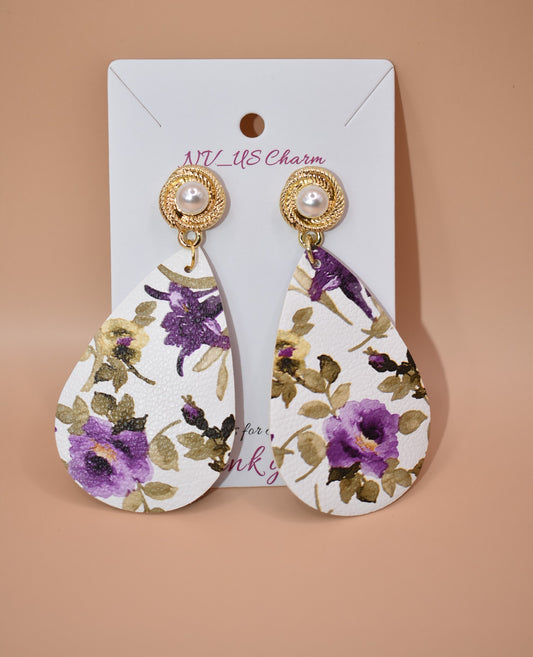 ﻿Spring is just around the corner and these pearl posts with purple flowered faux leather teardrops are a definite go to.  These are a one-of-a-kind piece.  These hang so pretty on the ear and are super comfortable for all day wear.  