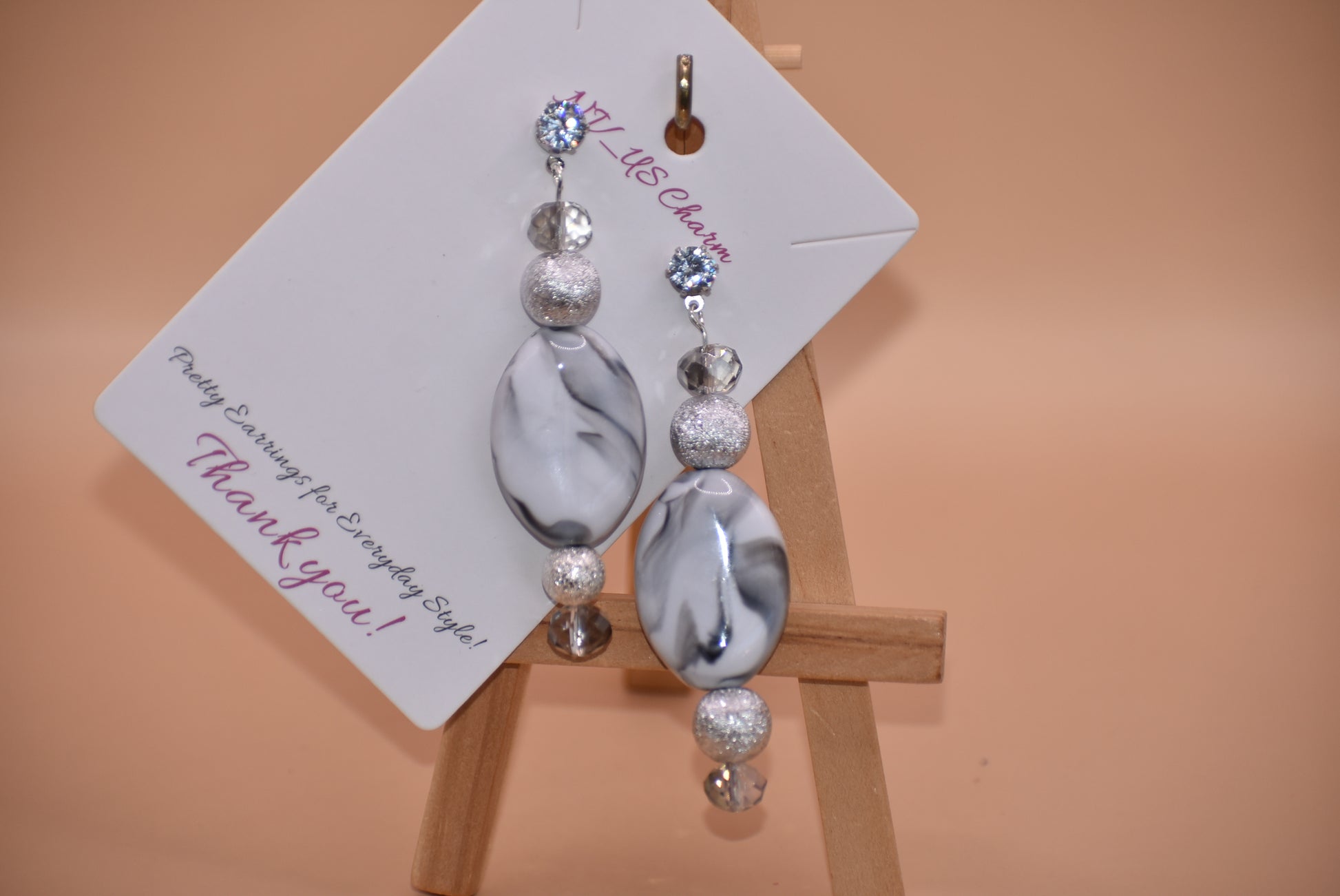 You will fall in love with these beautiful one-of-a-kind gray and silver earrings.  They are the perfect combination to wear on your ears for that special evening out.  They shimmer and compliment anything you will be wearing.  They sit on the ear with a crystal post for a little extra sparkle.  