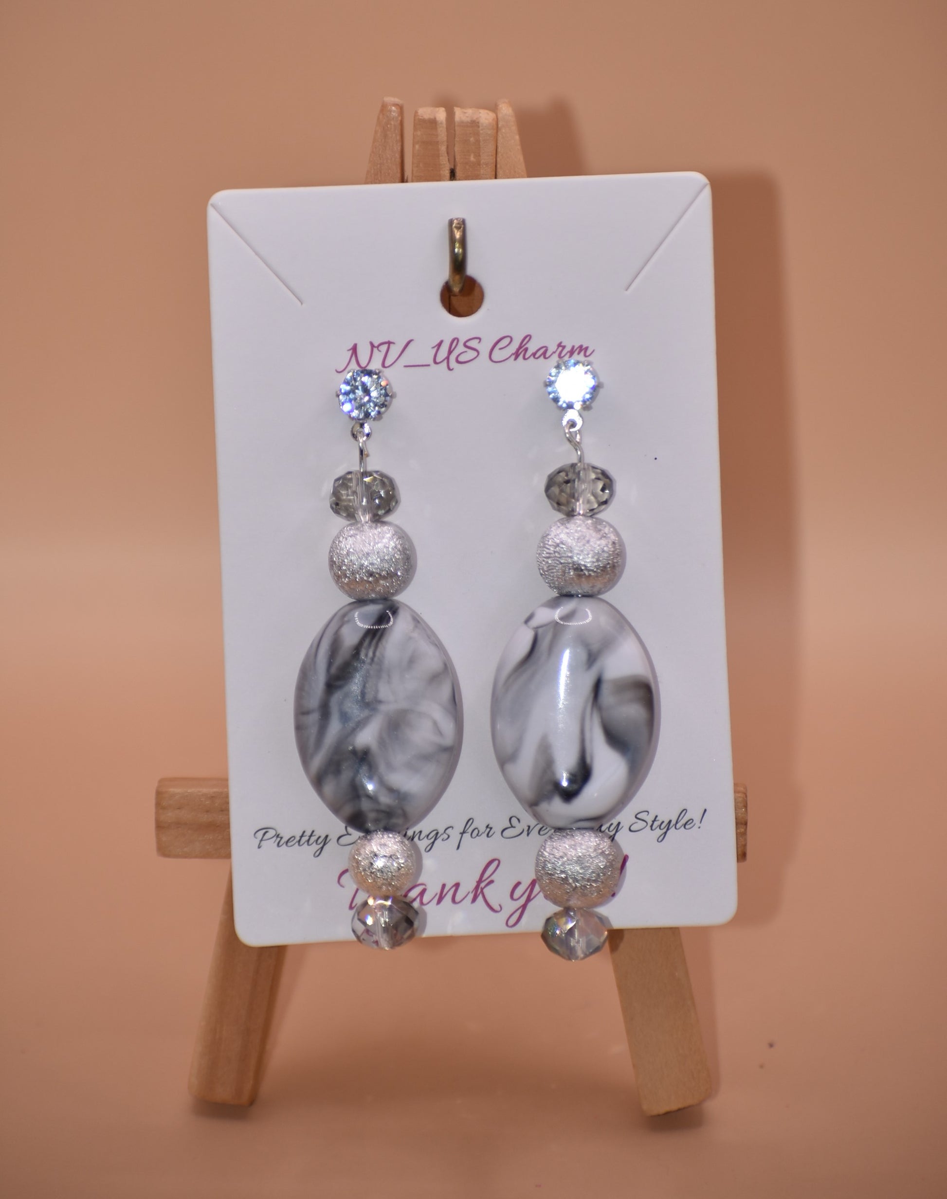 You will fall in love with these beautiful one-of-a-kind gray and silver earrings.  They are the perfect combination to wear on your ears for that special evening out.  They shimmer and compliment anything you will be wearing.  They sit on the ear with a crystal post for a little extra sparkle.  