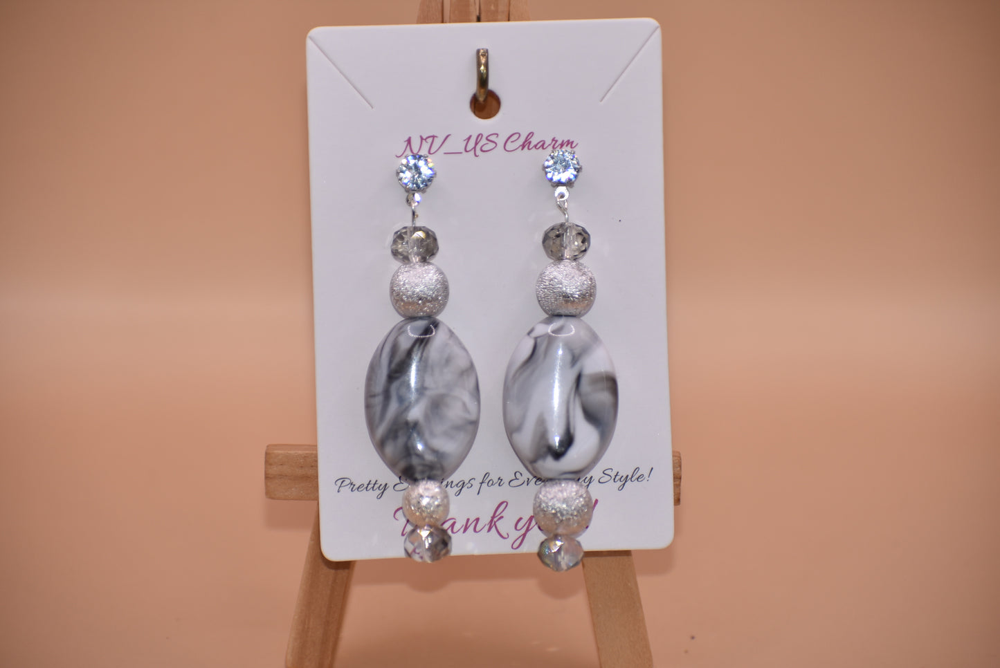 You will fall in love with these beautiful one-of-a-kind gray and silver earrings.  They are the perfect combination to wear on your ears for that special evening out.  They shimmer and compliment anything you will be wearing.  They sit on the ear with a crystal post for a little extra sparkle.  