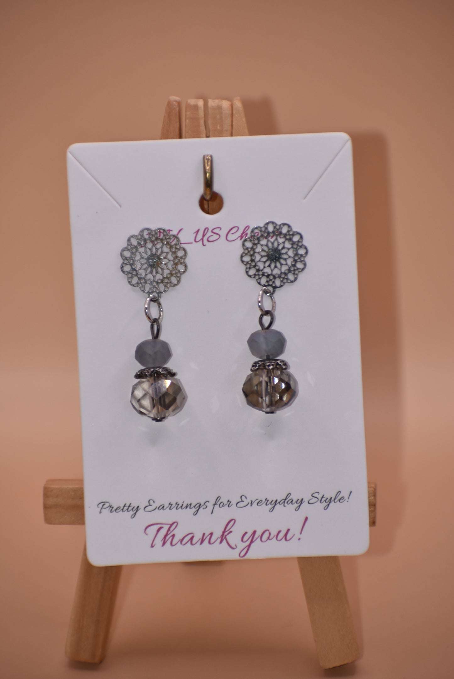 The Gray Collection 5 features filigree posts adorned with grey crystals and beads, perfect for everyday elegance. High-quality materials and intricate designs ensure a stylish and durable product, while classic hues add timeless beauty to any look.