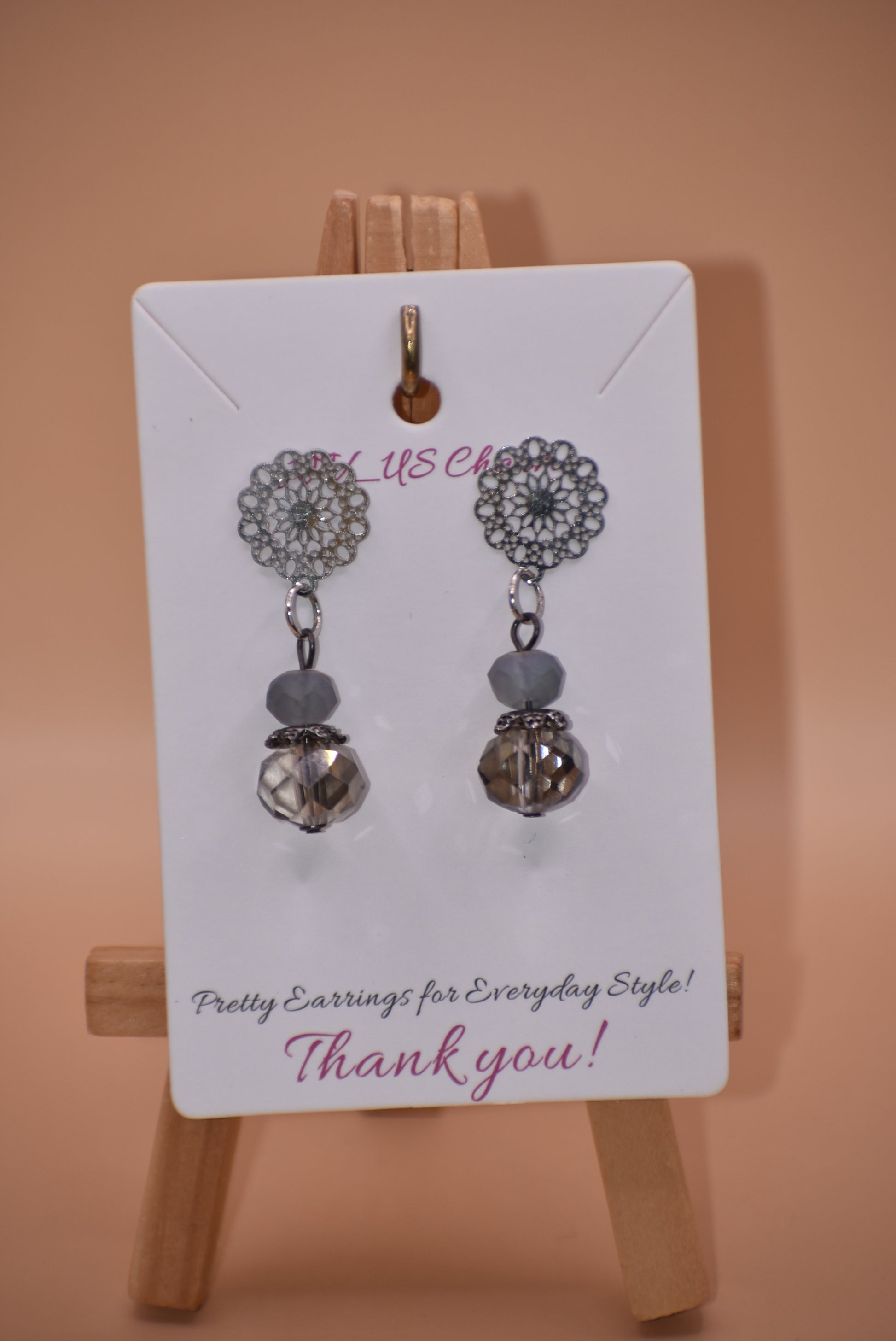 The Gray Collection 5 features filigree posts adorned with grey crystals and beads, perfect for everyday elegance. High-quality materials and intricate designs ensure a stylish and durable product, while classic hues add timeless beauty to any look.