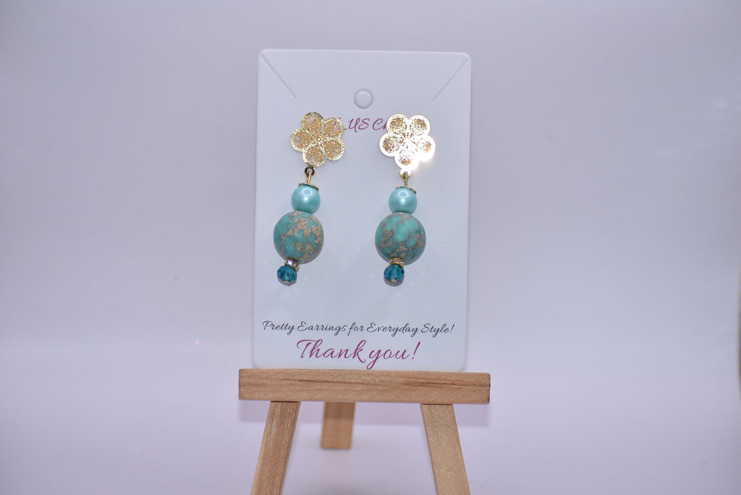 Get ﻿ready for adventure? These earrings are ready to go with you.  Gold flowered hanging post earrings with aqua pearls, pretty beads and diamond crystal accents bring these beauties together. Nickel free and hypoallergenic for sensitive ears.  Super comfortable on the ear.  One-of-a-kind-piece.