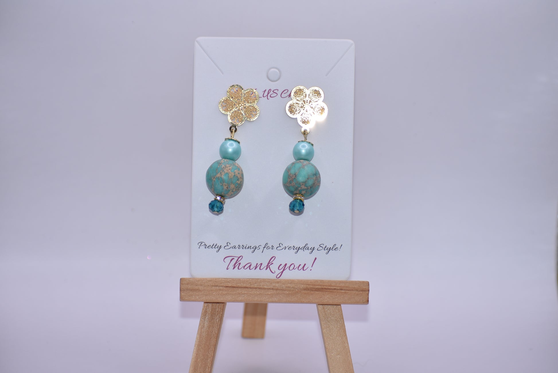 Get ﻿ready for adventure? These earrings are ready to go with you.  Gold flowered hanging post earrings with aqua pearls, pretty beads and diamond crystal accents bring these beauties together. Nickel free and hypoallergenic for sensitive ears.  Super comfortable on the ear.  One-of-a-kind-piece.