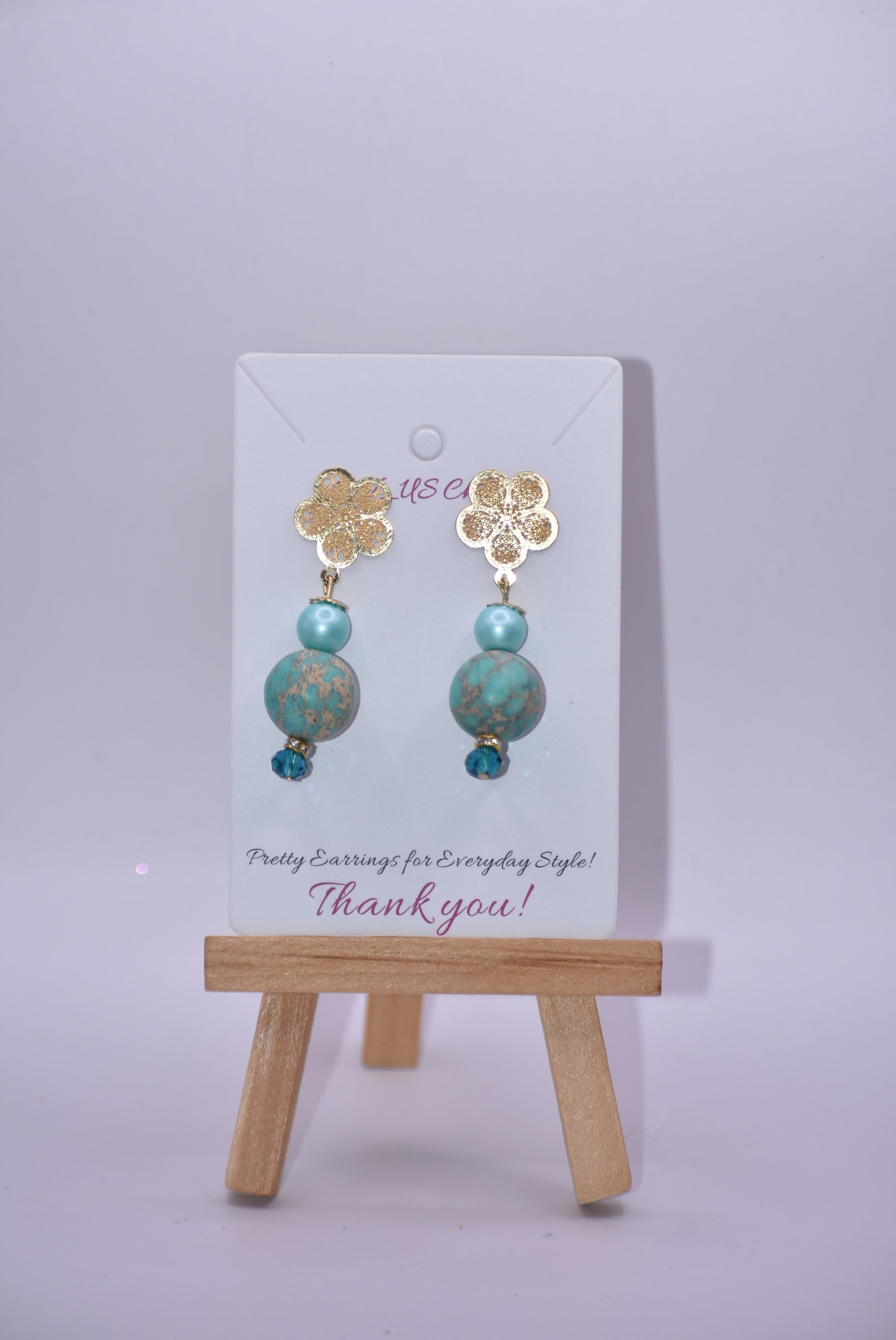 Get ﻿ready for adventure? These earrings are ready to go with you.  Gold flowered hanging post earrings with aqua pearls, pretty beads and diamond crystal accents bring these beauties together. Nickel free and hypoallergenic for sensitive ears.  Super comfortable on the ear.  One-of-a-kind-piece.