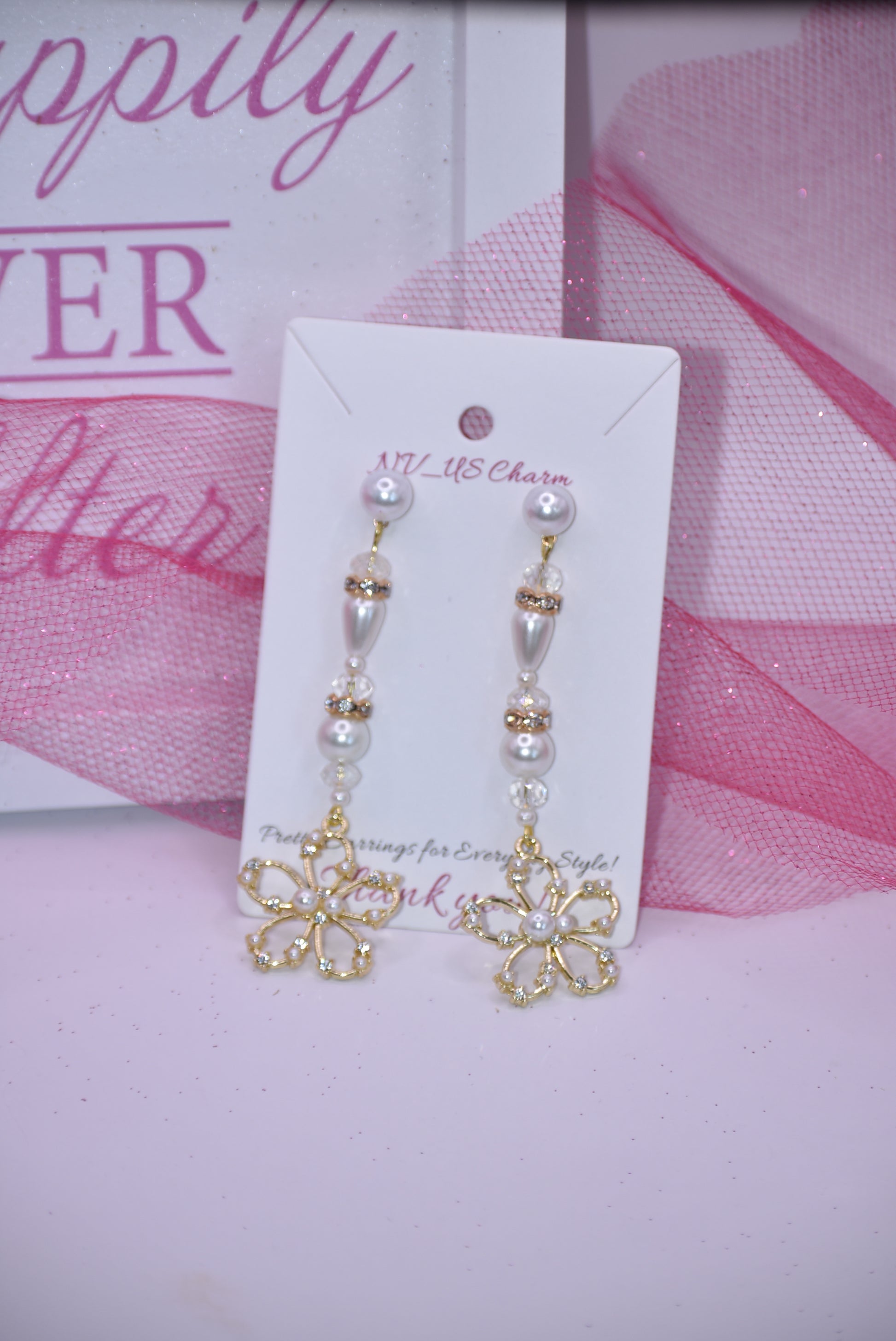 This one of a kind piece of jewelry is a beautiful addition to a bride's special day. The long earring hangs gracefully and is decorated with gorgeous gold crystals and pearls. The pearl posts add an extra touch of sparkle and the gold flower made with pearls and crystals is an exquisite center piece. Perfect for making any bride feel extra special on her wedding day.